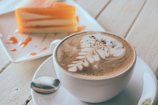 Coffee and orange cake on wooden table, Soft focus, Vintage tone
