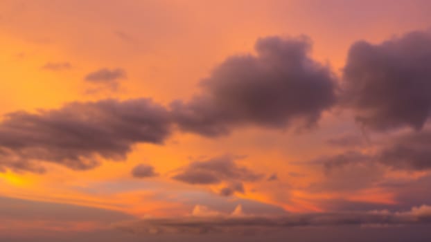 Dramatic sunset sky with clouds. Blur or defocus image.