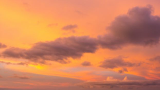 Dramatic sunset sky with clouds. Blur or defocus image.