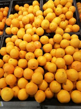 Fresh mandarin oranges fruit on shelf in supermarket.