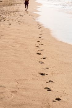 Footprints of a man walking on the beach. Travel concept