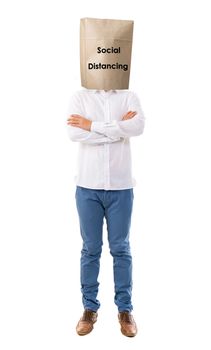 Social distancing to avoid the spread of coronavirus. Man covered head with paper bag.