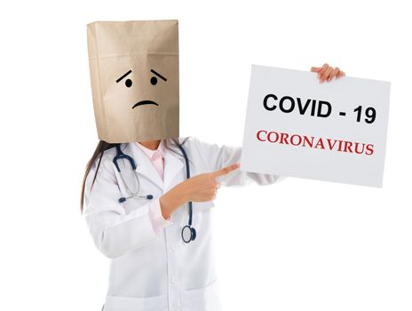 Medical staff holding a card with covid 19 on it.