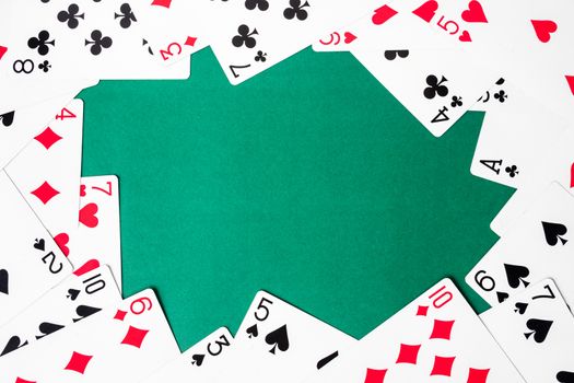 Playing cards on green background. Free space for text