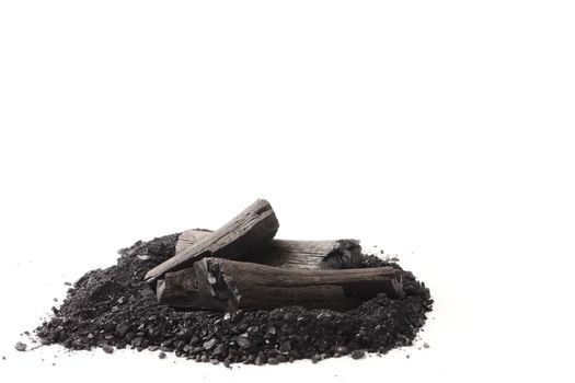 Charcoal and powder (activated carbon) on white background. Free space for text