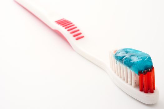 Close up of Toothbrush with toothpaste on a white background.