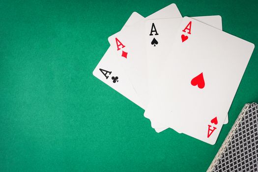 Playing cards, Four aces on green background. Free space for text
