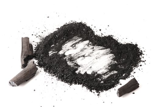 Charcoal and powder (activated carbon) on white background. Free space for text