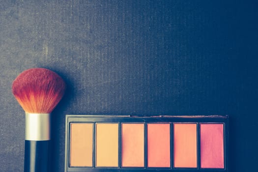Makeup brush and palette on black background, Vintage tone, Free space for text.
