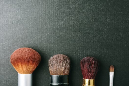 Makeup brushes on black background, Free space for text.