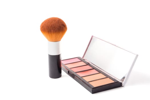 Makeup brush and palette on white background.