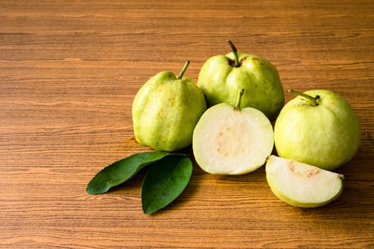 Fresh guava fruit on wooden table background.