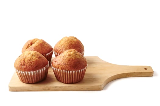 Banana cupcakes on a wooden tray, white background