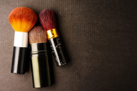 Makeup brushes on black background, Free space for text.