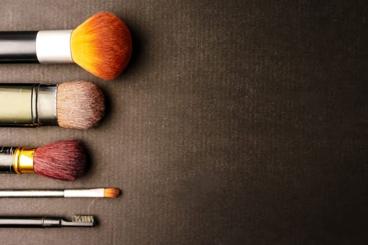 Makeup brushes on black background, Free space for text.