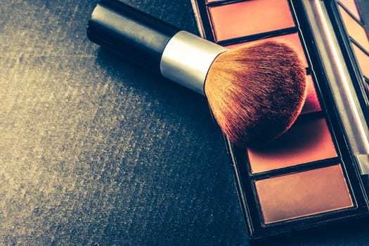 Makeup brush and palette on black background, Vintage tone, Free space for text.