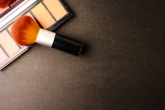 Makeup brush and palette on black background, Free space for text.