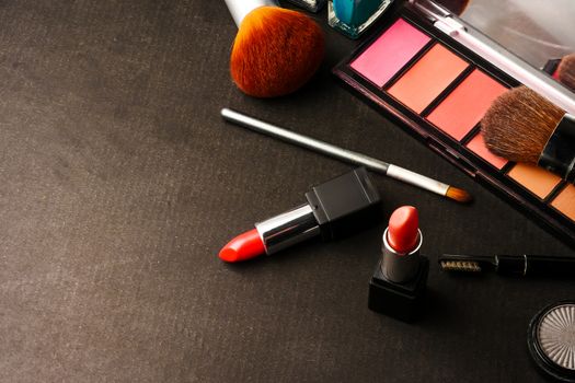 Top view of cosmetics set for makeup on a blue background. Free space for text.