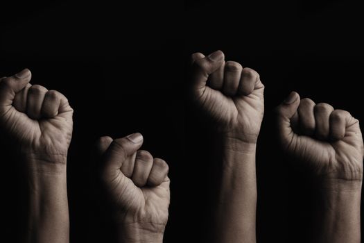 Concept against racism or racial discrimination by showing with hand gestures fist or solidarity.