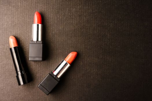 Top view of Lipsticks on black background. Free space for text