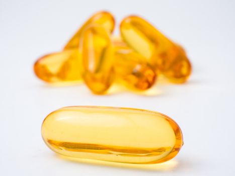 Fish oil capsules on a white background, Vitamin D supplement, selective focus
