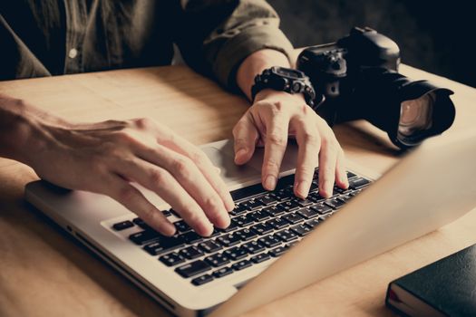 Close up of photographer editing his images on laptop.