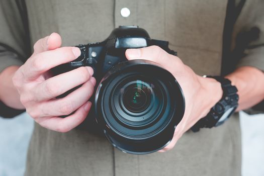 Close up of casual man is holding a camera, Photography Concept.