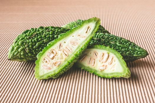 Bitter melon or bitter gourd on wooden background.