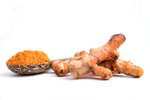 Turmeric roots with turmeric powder on white background.