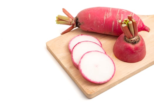 Fresh Pink Radishes on wooden tray over white background.