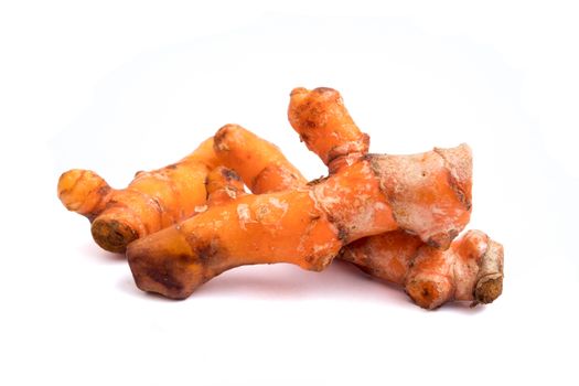Turmeric roots on white background.