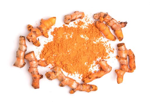 Turmeric roots with turmeric powder on white background.