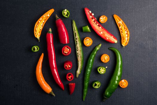Colorful mix of chili pappers on black background.