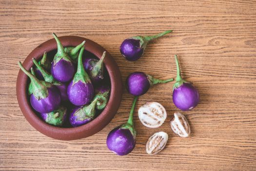 Fresh Purple eggplants on wooden table.