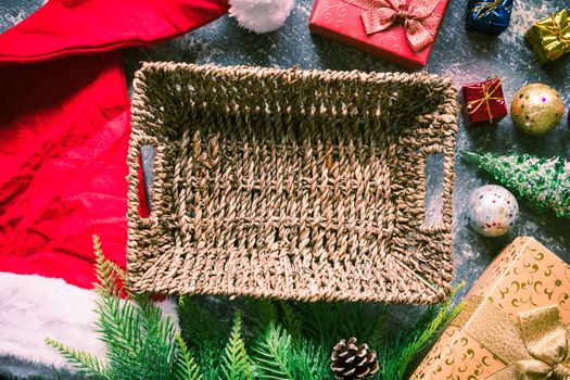 Empty basket with christmas decoration on gray grunge background.