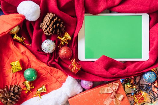 Top view of tablet and christmas decoration on the table.