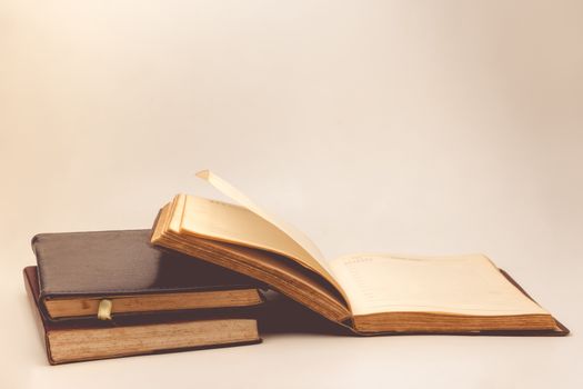 A stack of old books with vintage background.