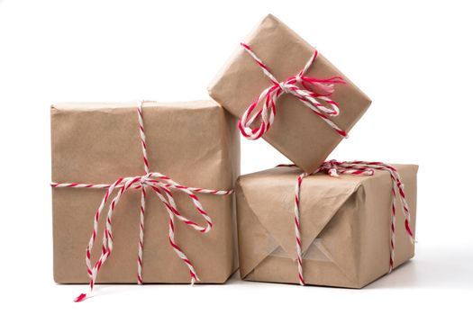 Gift packages wrapped in brown paper on white background.