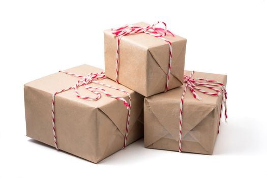 Gift packages wrapped in brown paper on white background.