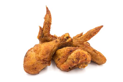 Fried chicken legs and wings on a white background.