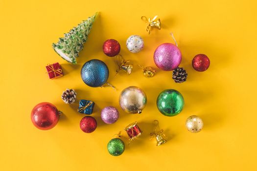 Top view of Christmas decorations on a yellow background.