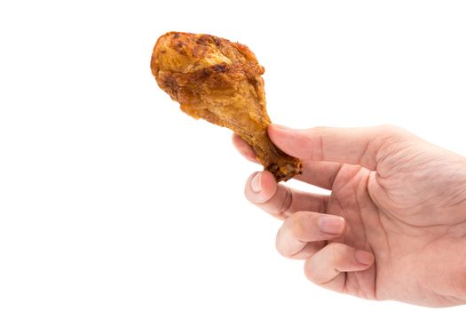 Hand holding Fried chicken leg on a white background.