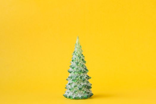 Christmas decoration with pine tree on yellow background.