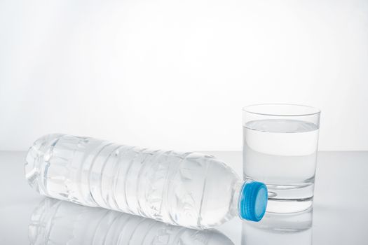 water in plastic bottle with glass