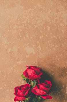 Bunch of Red roses on brown grunge board background. Free space for text