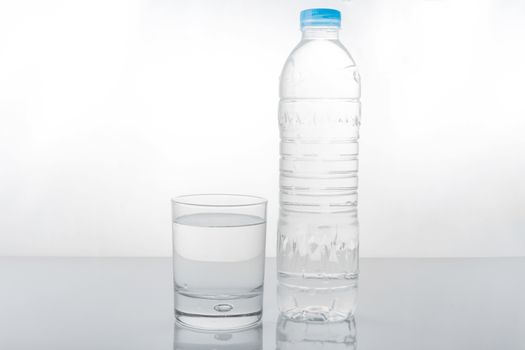 water in plastic bottle with glass