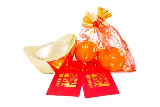 concept image of the chinese new year - Gold Ingot ,red packet and mandarin orange in the red auspicious bag