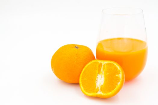 Orange juice and slices of orange on white background