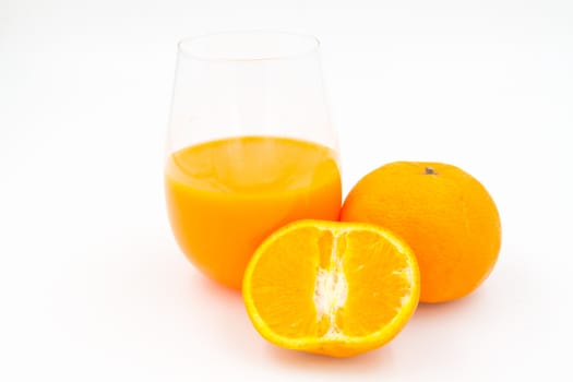Orange juice and slices of orange on white background