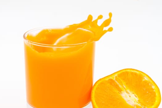 Orange juice and slices of orange on white background